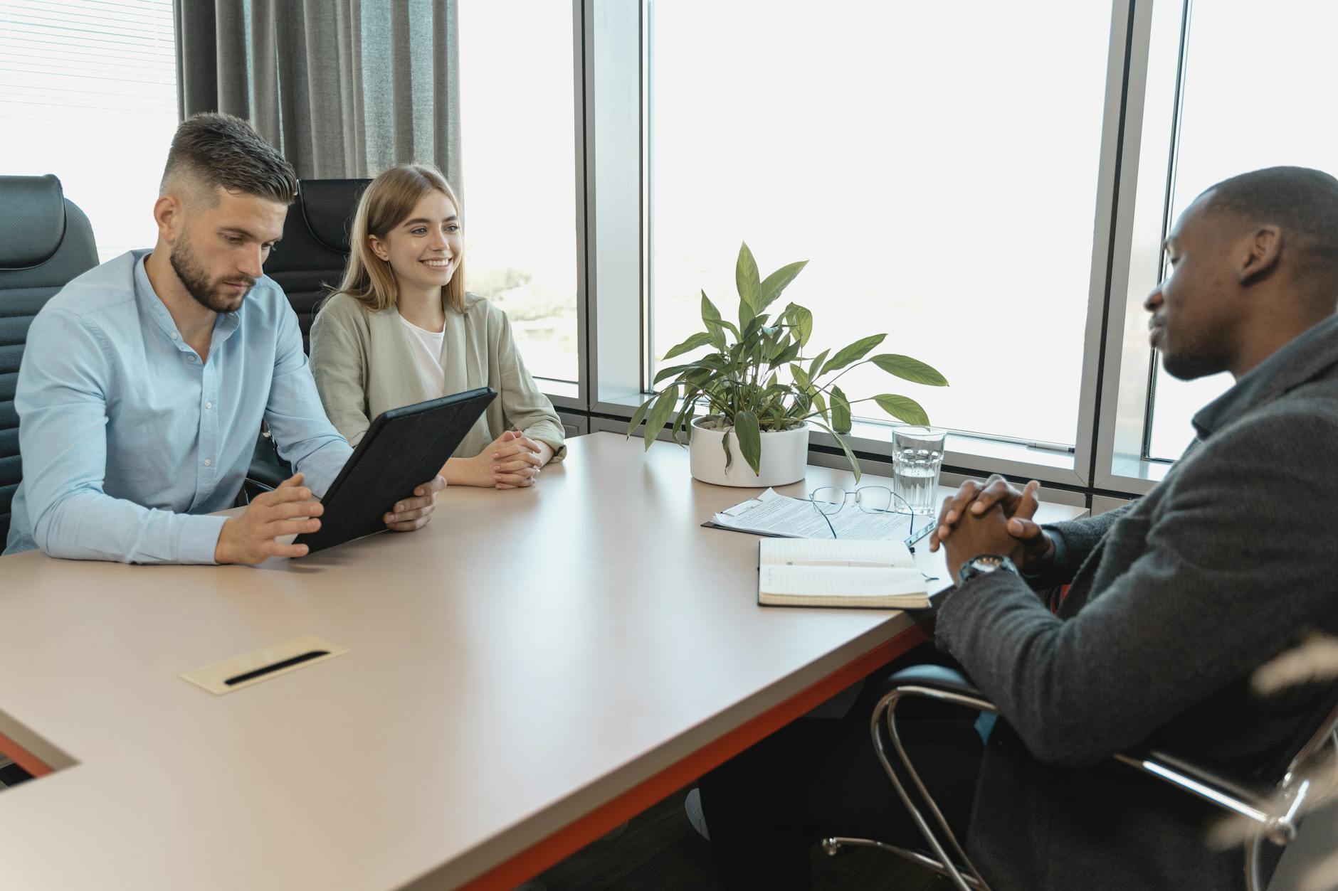 A Business Interview With Three People In A Modern