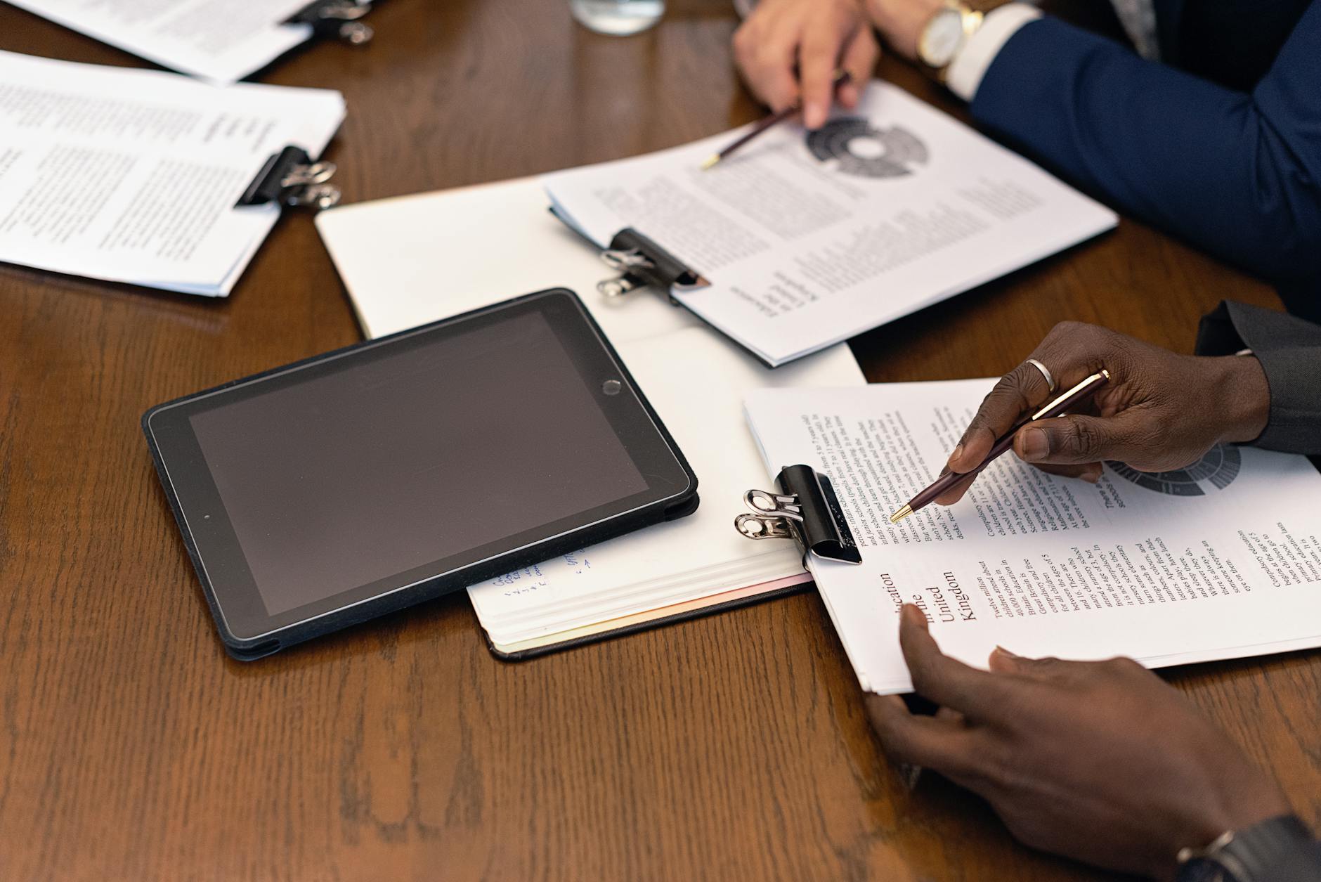 A Business Meeting With Tablets And Documents Sho