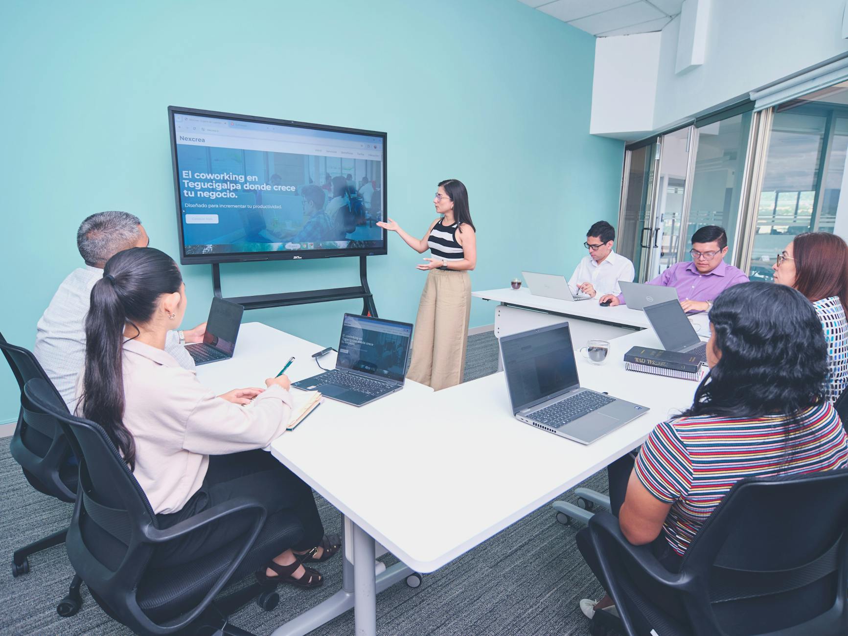A Diverse Team Collaborating On Technology Solutions In A Meeting