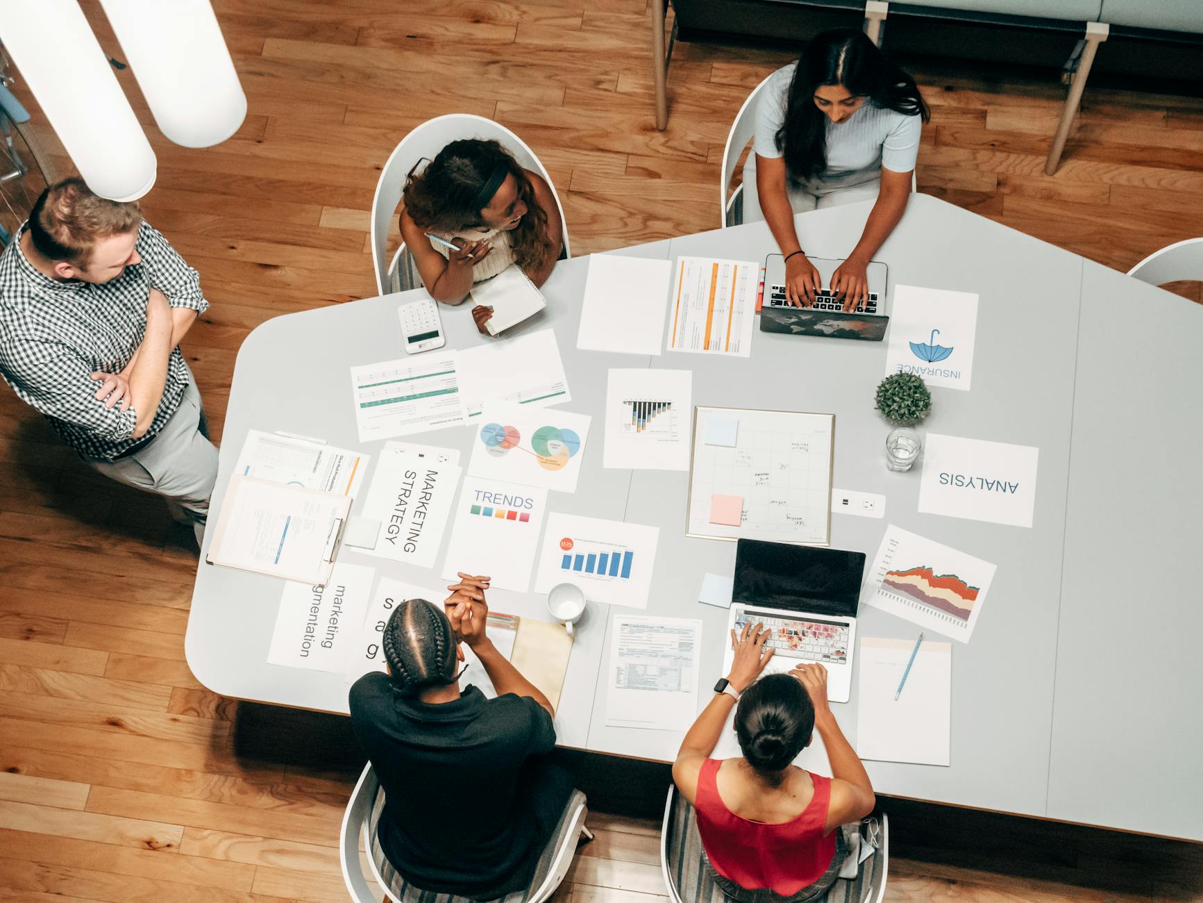 A Diverse Group Working On Marketing Strategies Wi