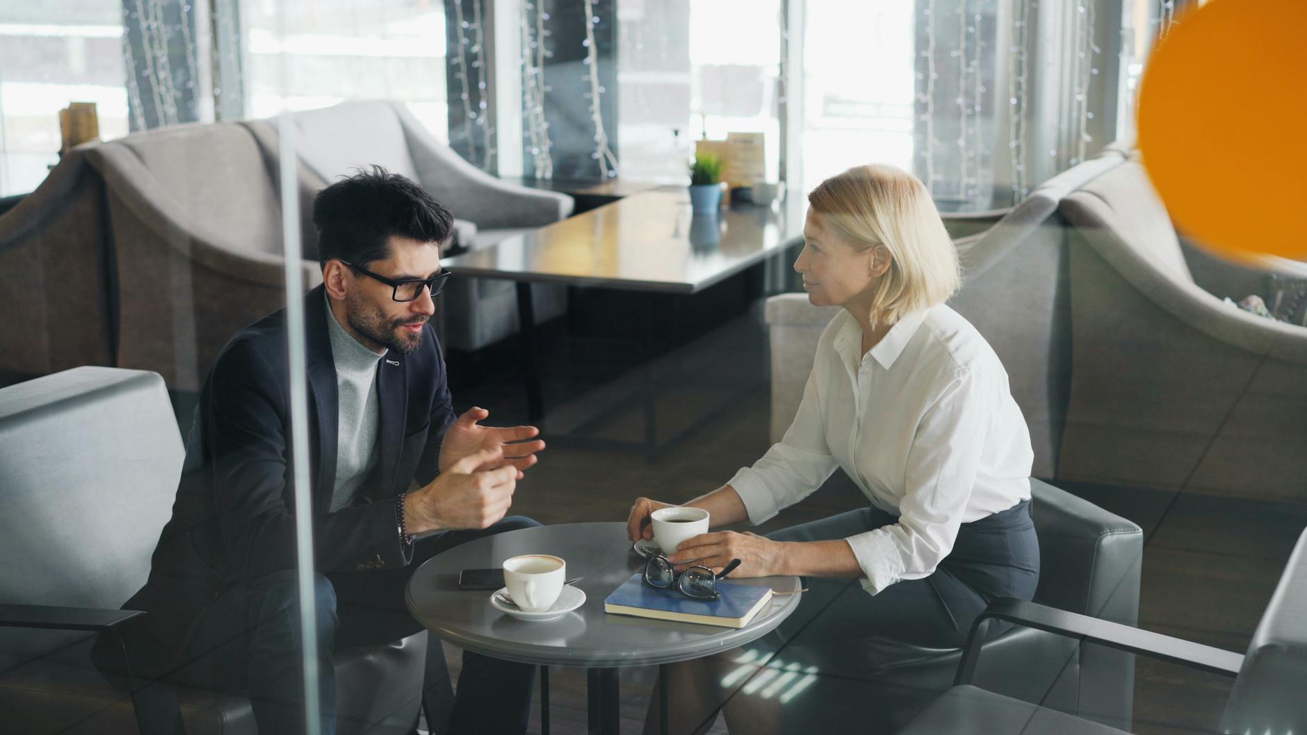 Business Professionals In A Discussion Over Coffee 2
