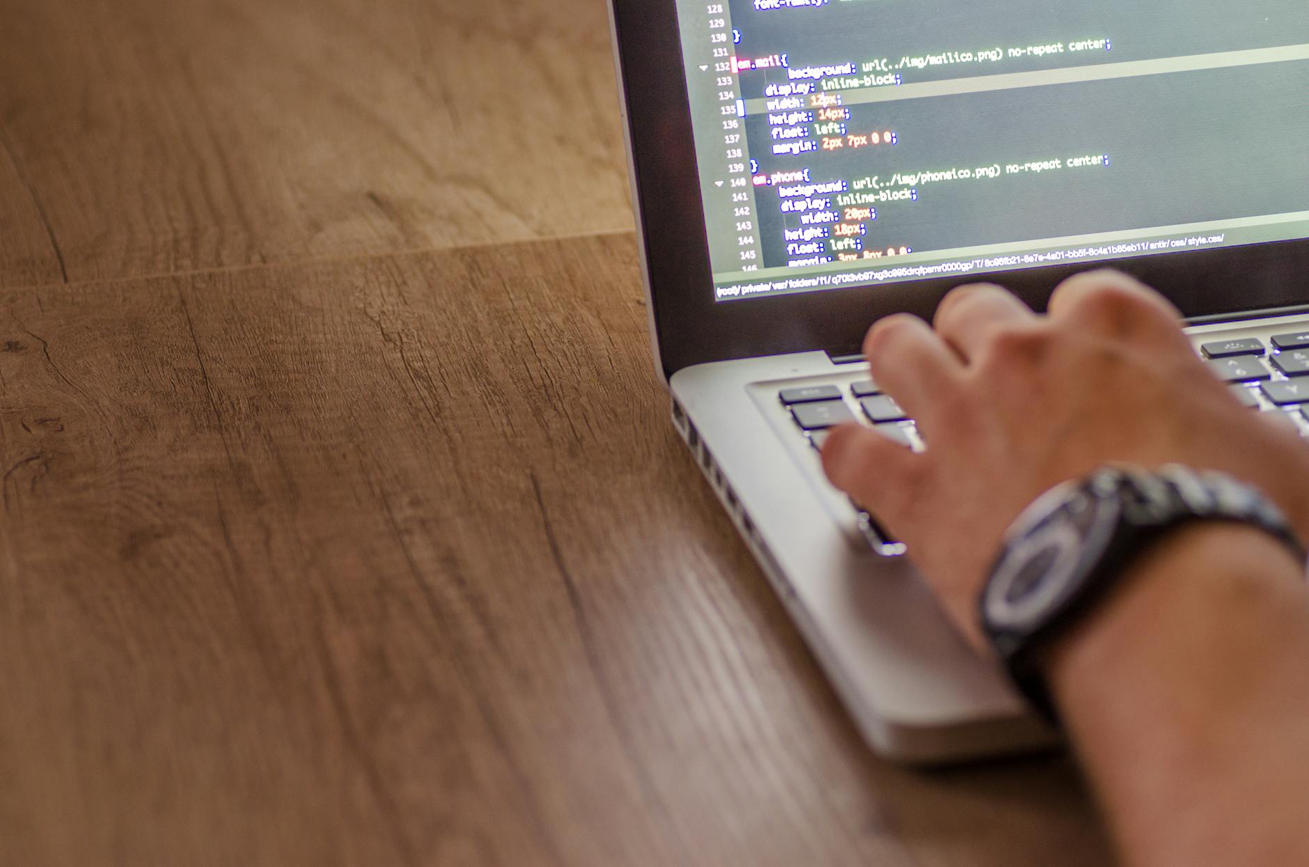 Developer Writing Code On A Laptop Showcasing Programming Skills