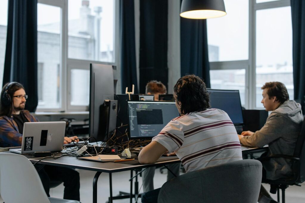 Team Of Developers Working Together On Computers In A Modern Tech Office.