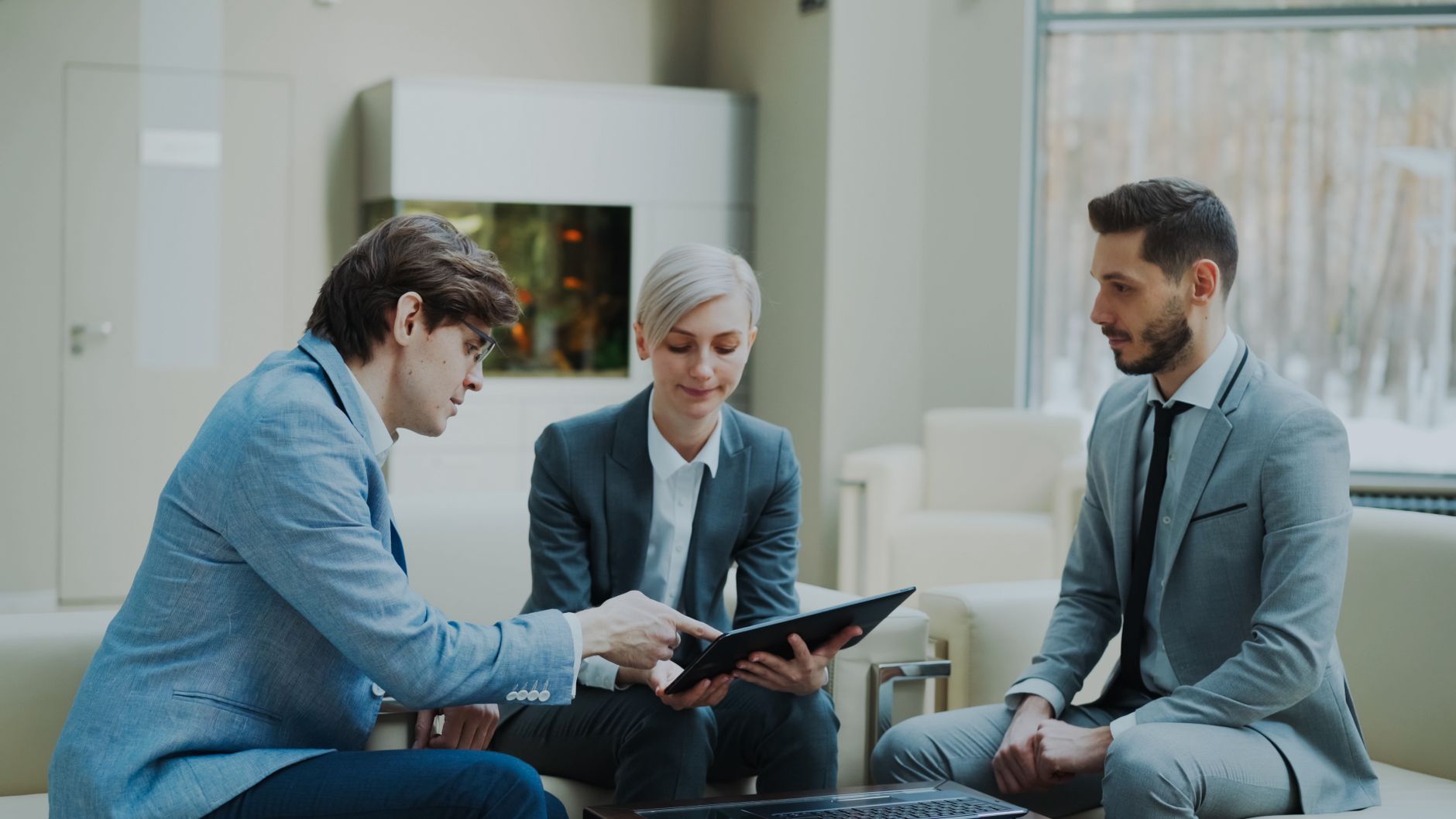 Three Professionals Engaging In A Business Meeting