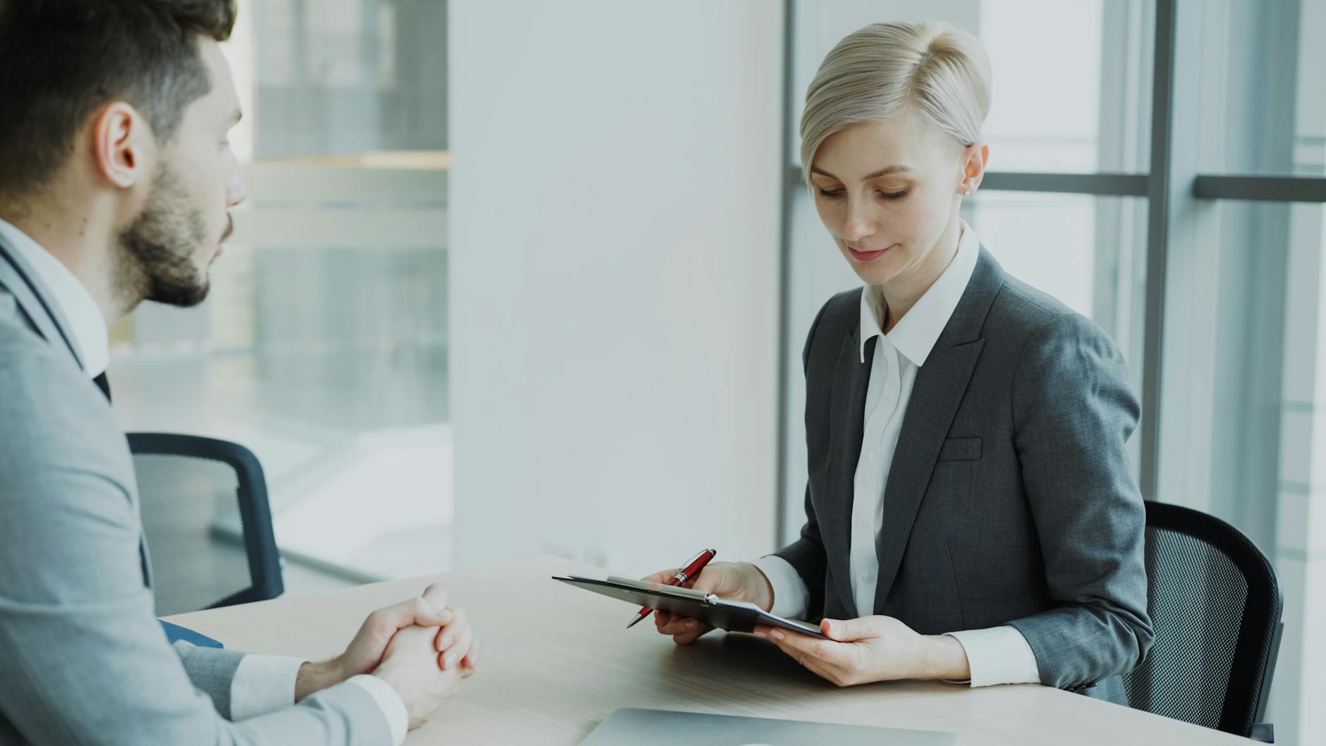 Two Professionals In A Modern Office Discussing Bu