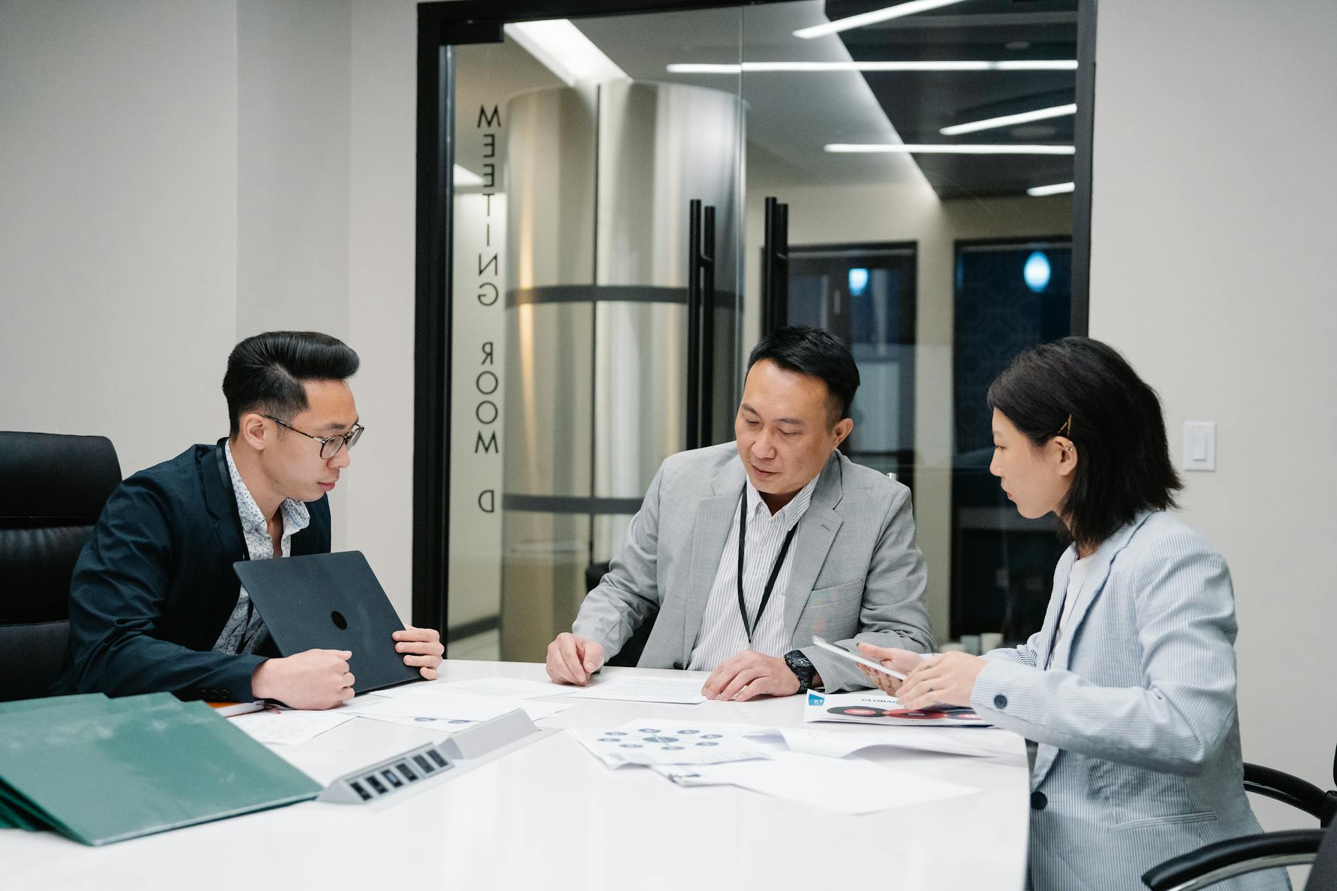 Business Meeting With Three Professionals Collabor