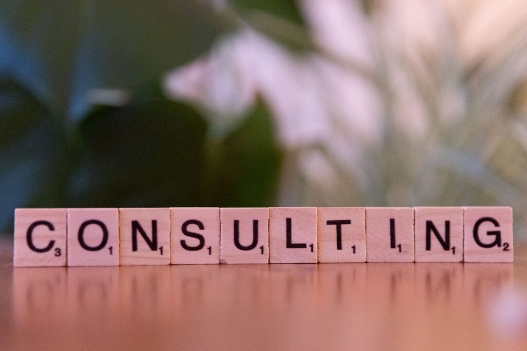 Wooden Letter Tiles Spelling 'Consulting' With A Blurred Background. Ideal For Business Concepts.