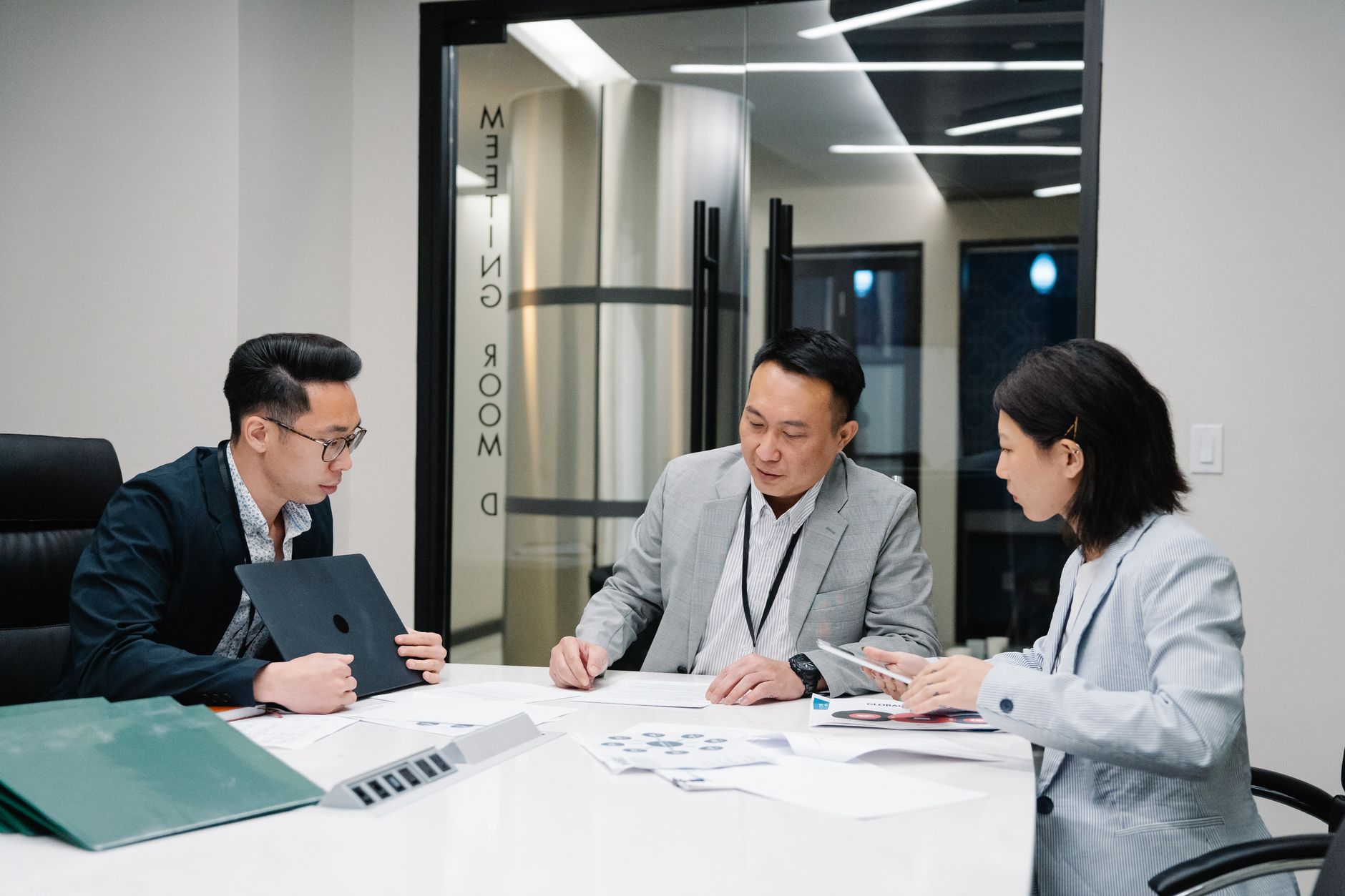 Business Meeting With Three Professionals Collabor