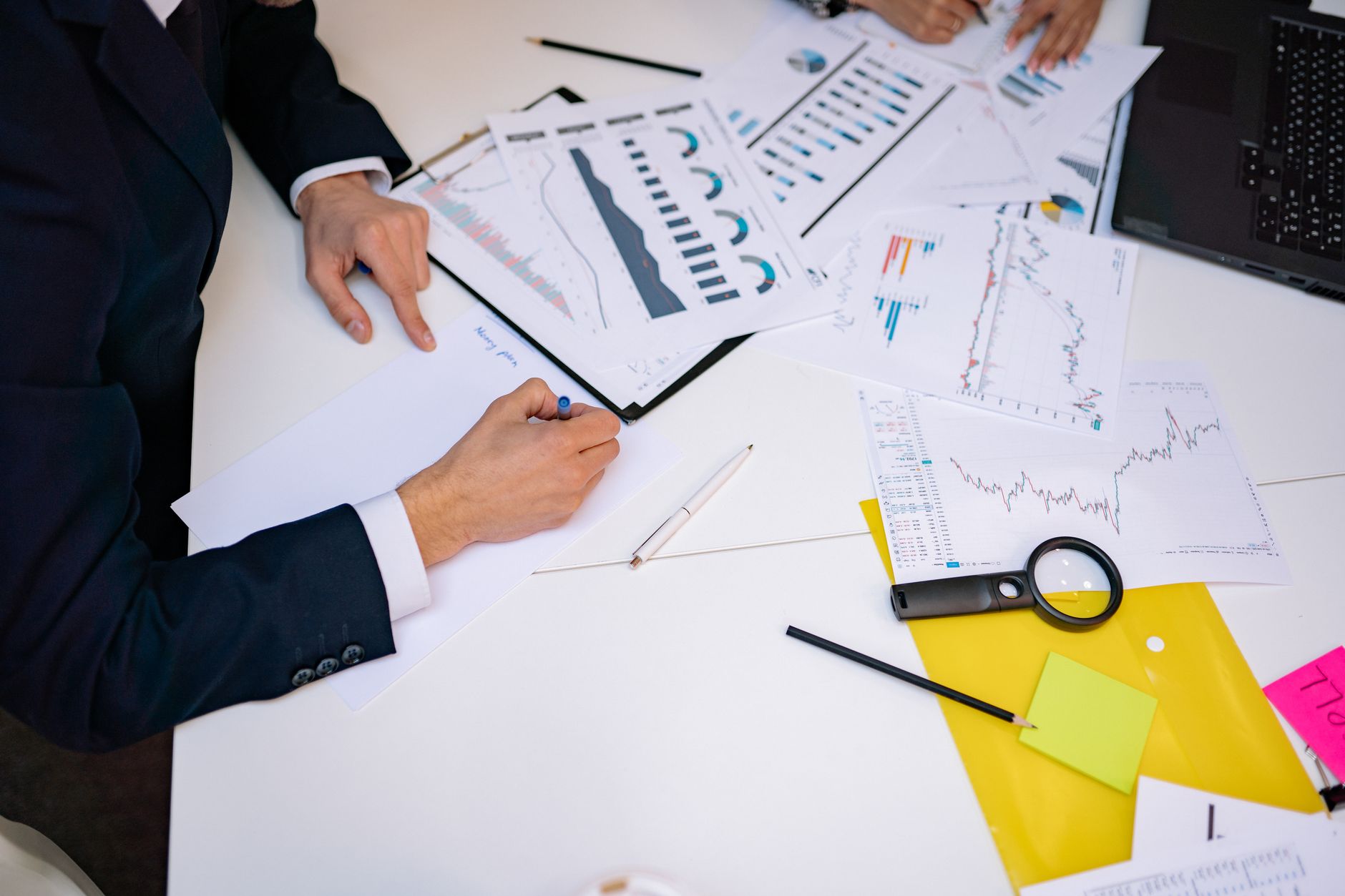 Close Up Of A Desk Cluttered With Financial Charts 3