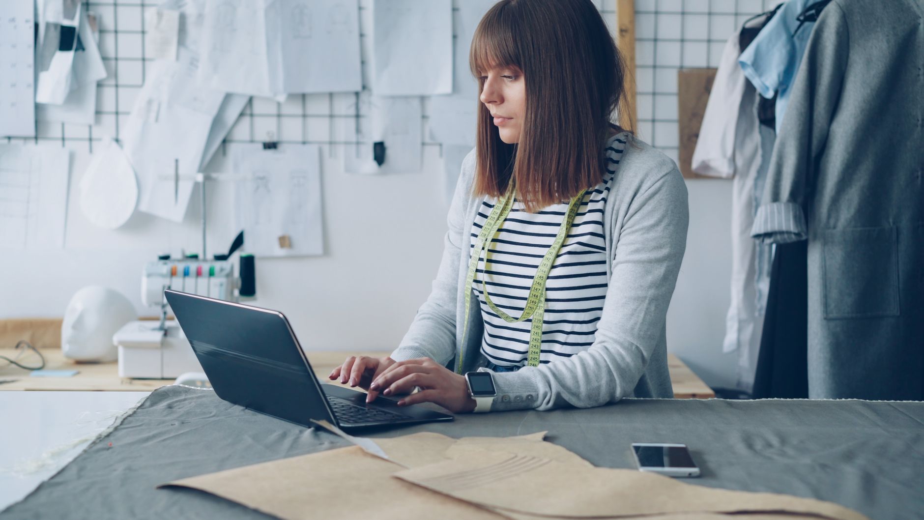 Female Fashion Designer Working On Laptop In Creat