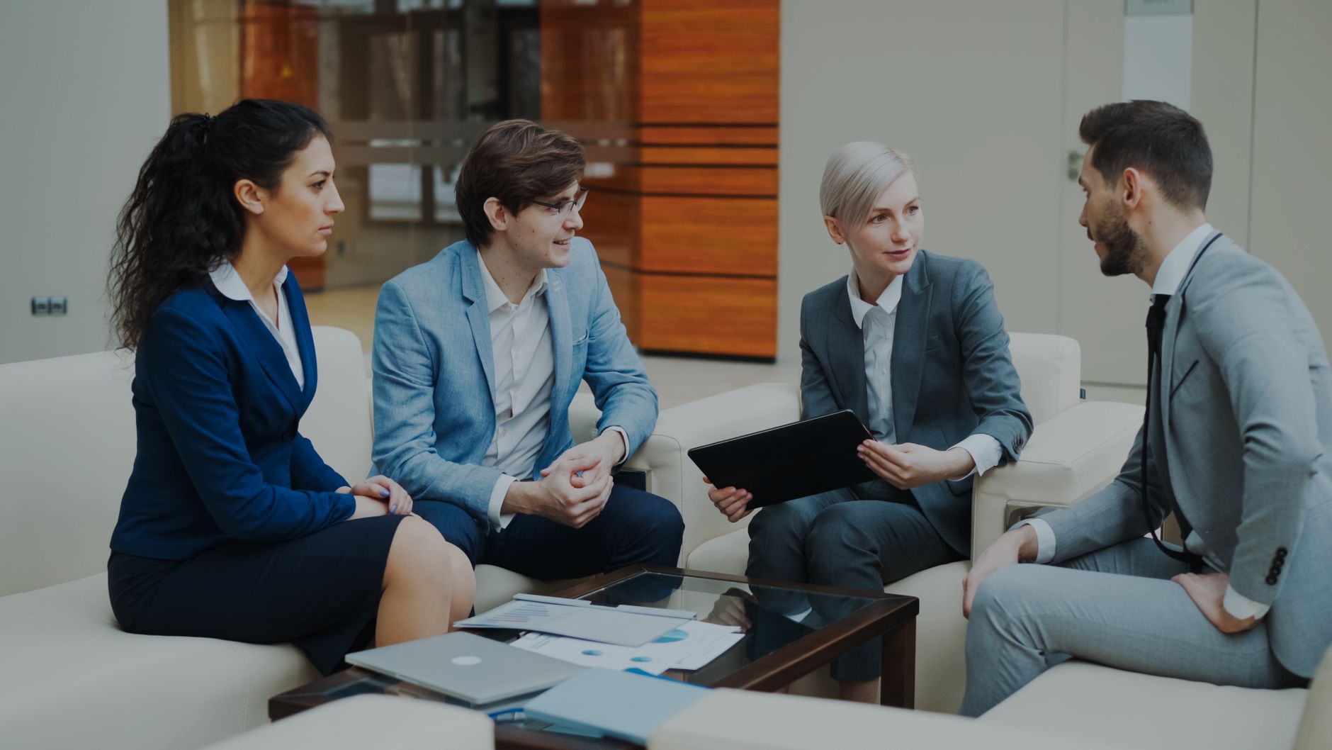 Group Of Professionals Discussing Strategy At An O 2