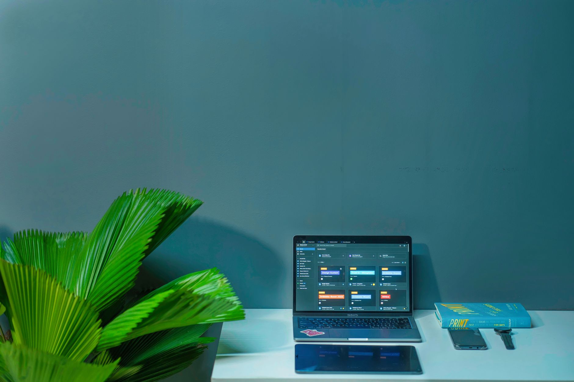Sleek Office Desk Setup Featuring A Laptop Tropic